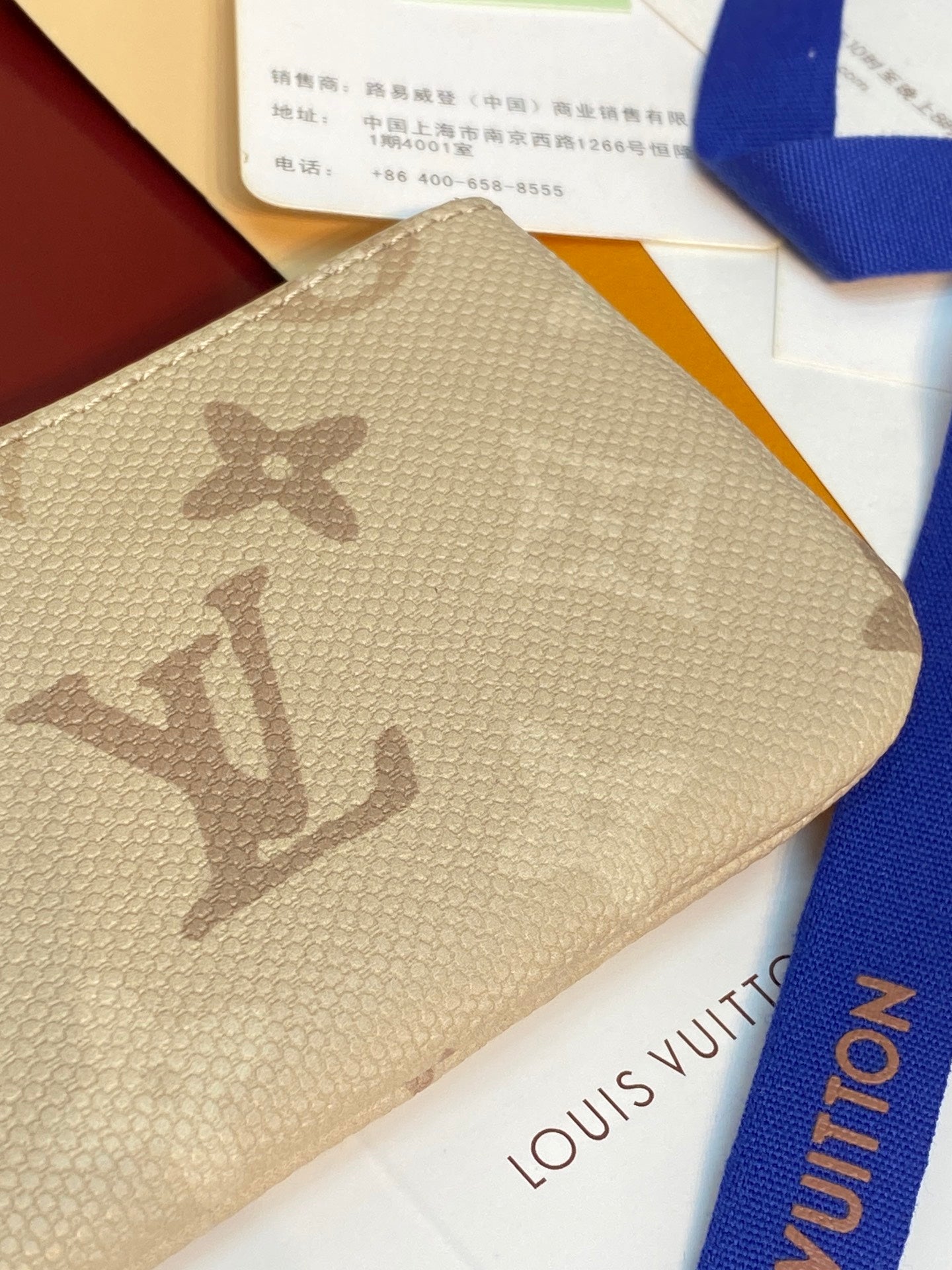 Louis Vuitton beige monogram zip pouch close-up with top zipper edge