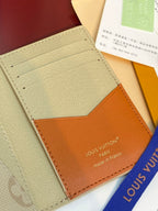Beige card holder wallet with tan leather pocket and embossed monogram pattern