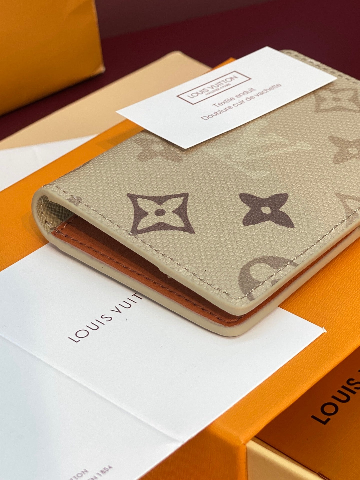 Beige monogram card holder wallet with front logo pattern and tan edge trim