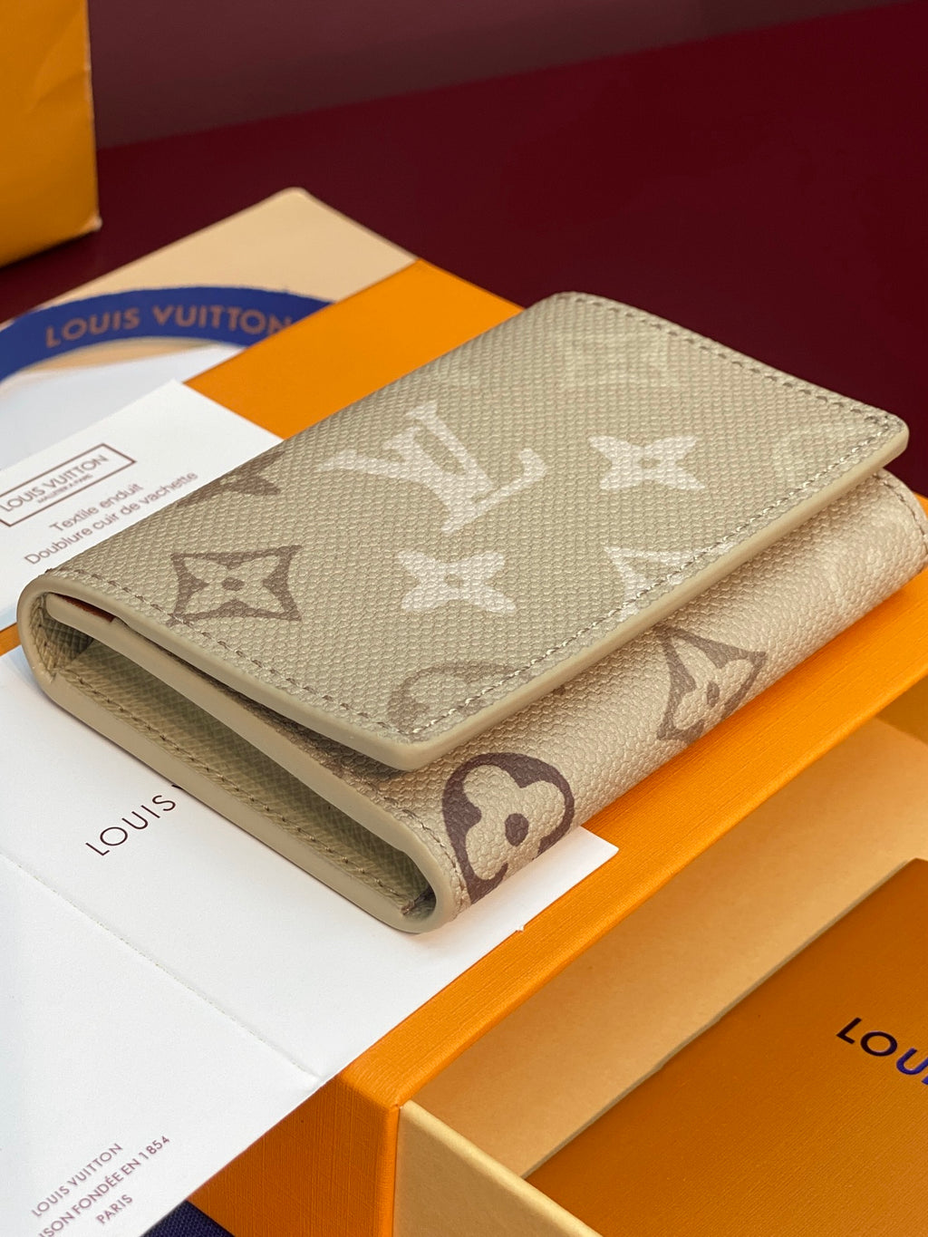 Louis Vuitton monogram wallet, beige canvas with wraparound design and gold button