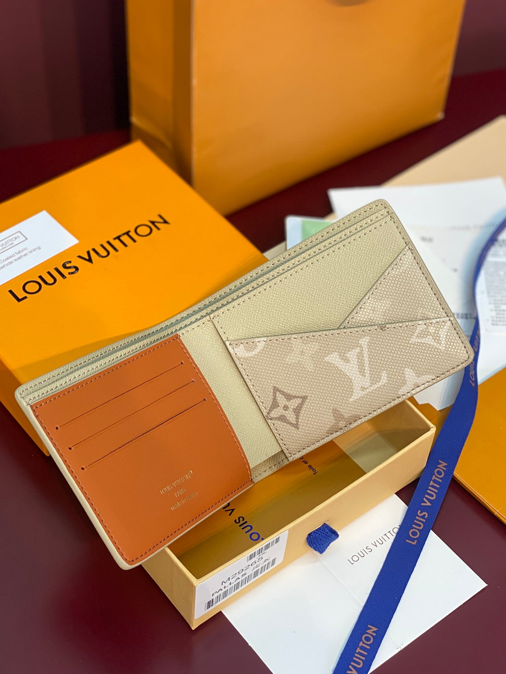Louis Vuitton small bag with beige monogram canvas flap, open card slot view, tan leather