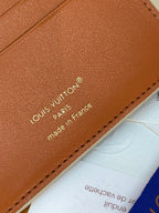 Louis Vuitton small bag close-up of tan leather branding and stitched border