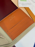 Louis Vuitton small bag interior with tan leather card slots and stitched edges