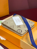 Louis Vuitton small bag with beige monogram canvas and tan trim on display
