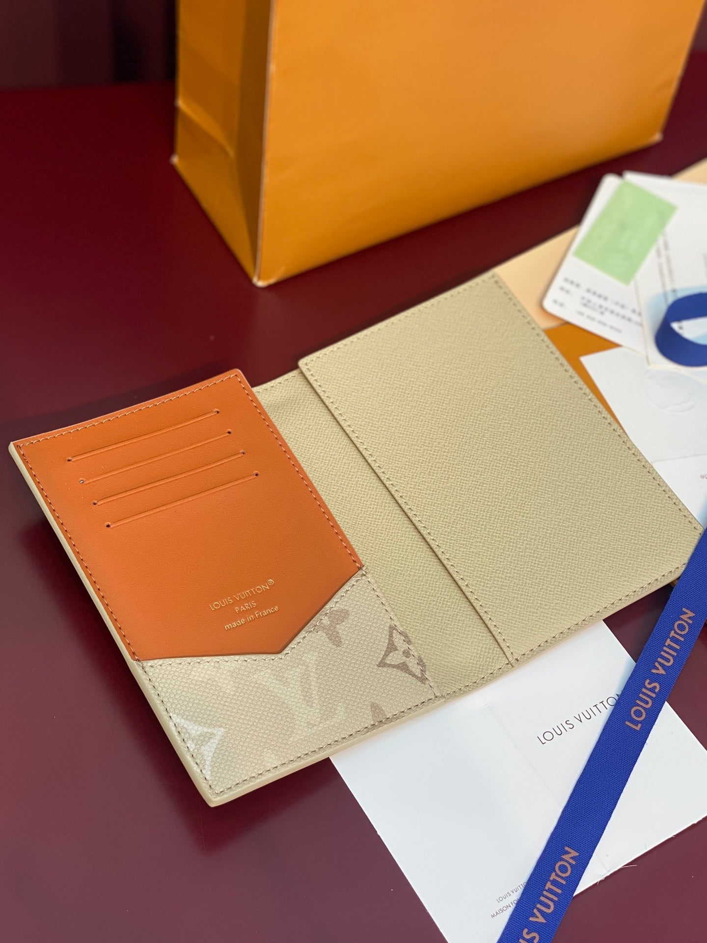 Louis Vuitton small bag open, beige exterior with orange interior card slots