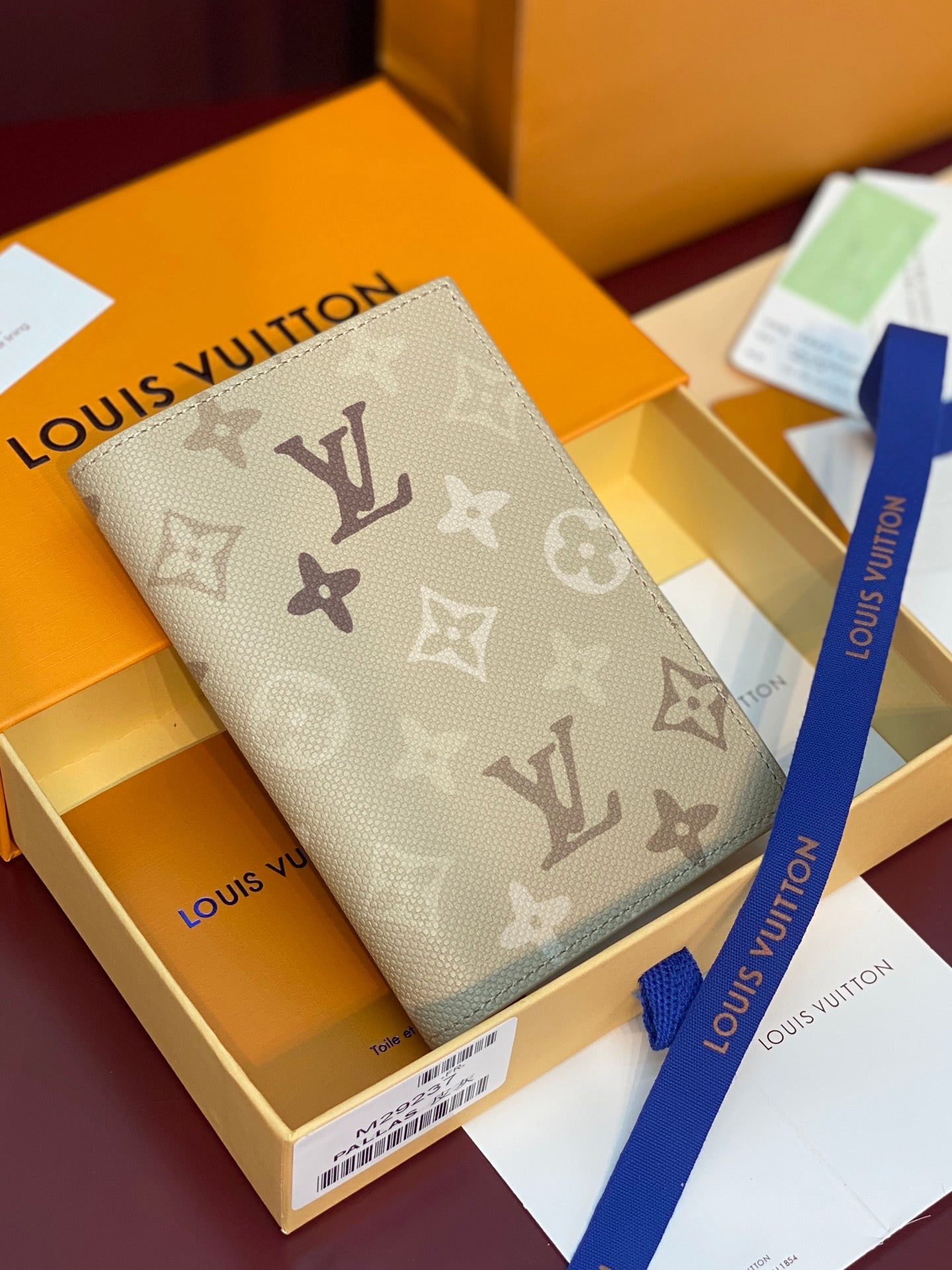 Beige Louis Vuitton monogram card holder with border and stitched edges