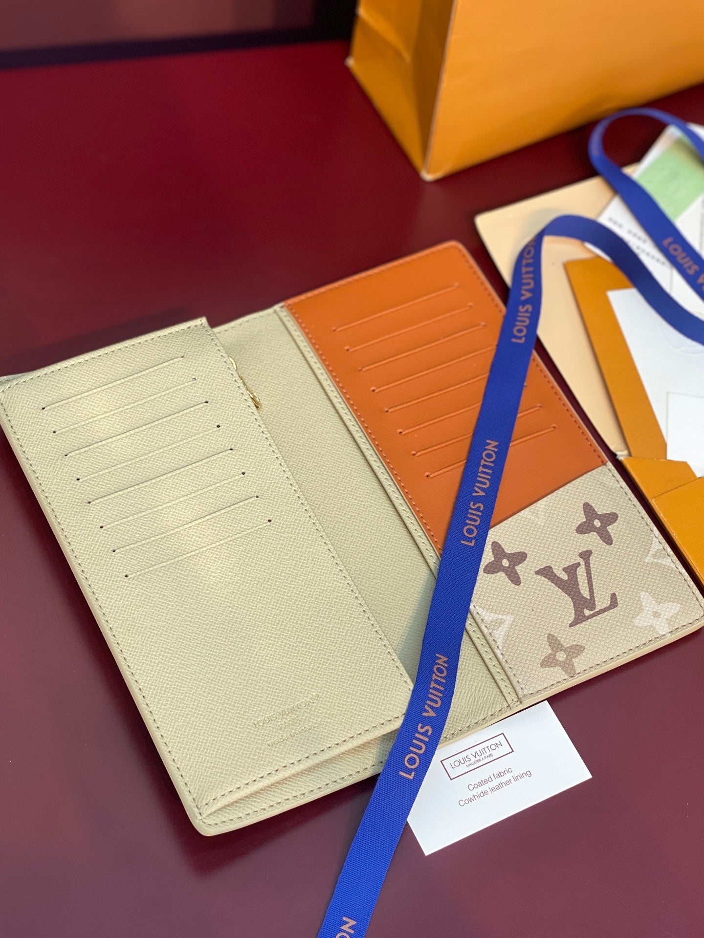 Beige and orange card wallet set with multiple card slots and embossed monogram.
