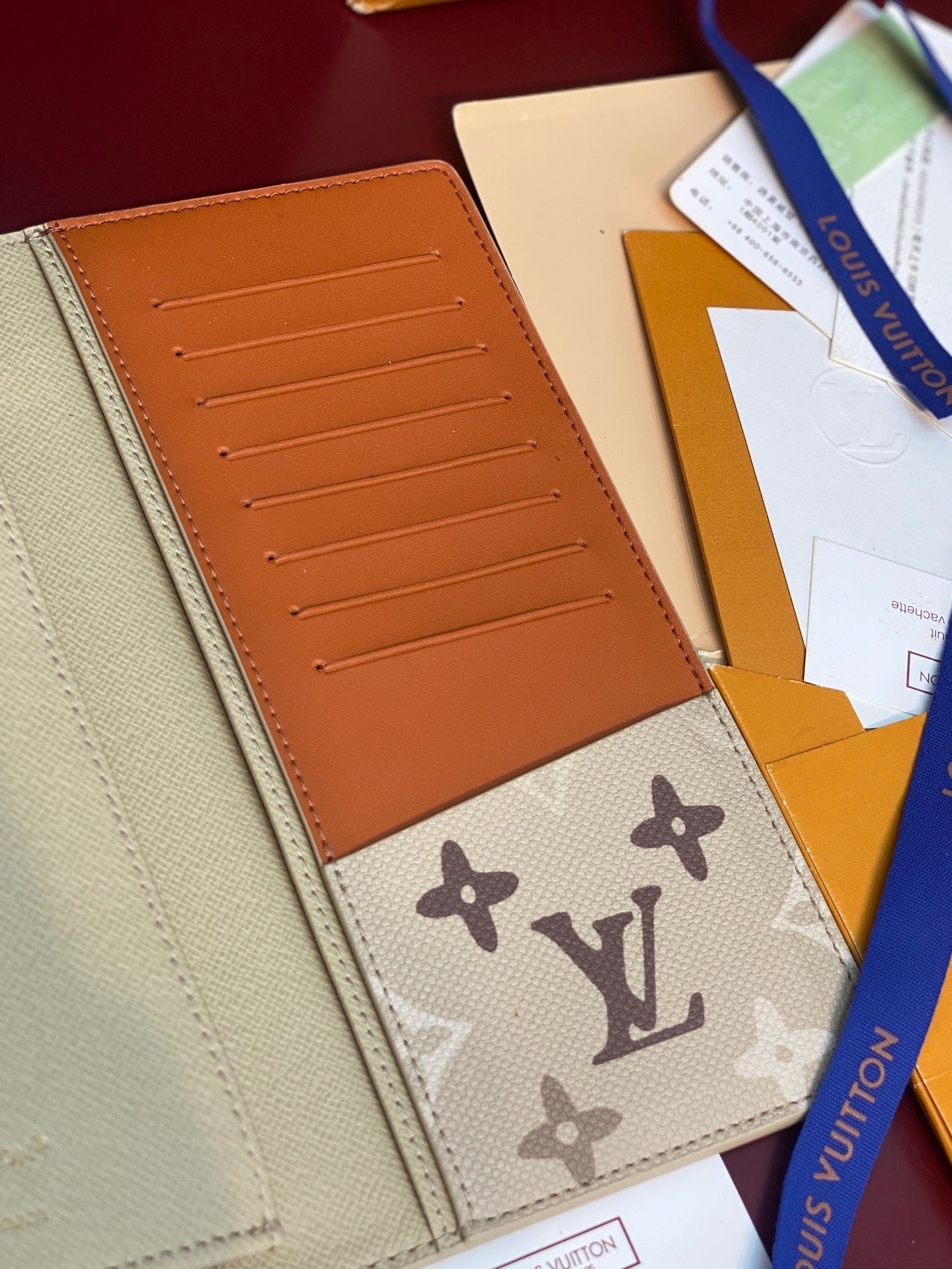 Louis Vuitton monogram card wallet interior with orange card slots and cream pocket
