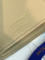Louis Vuitton monogram wallet detail with embossed logo and stitched leather trim