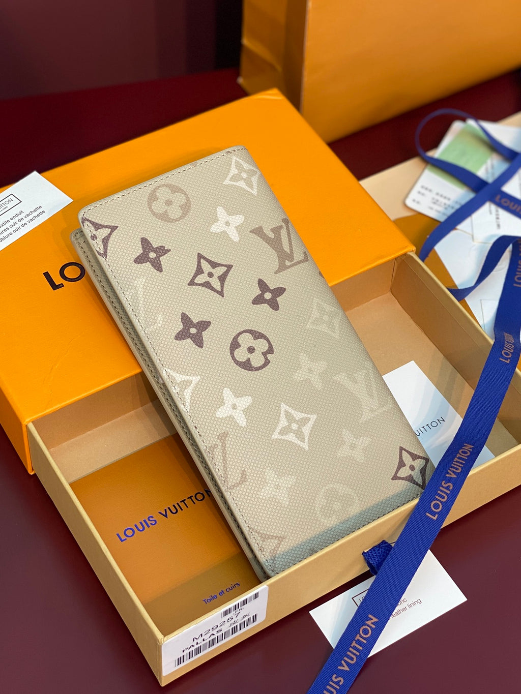 Louis Vuitton monogram long wallet in light gray with repeating logo pattern
