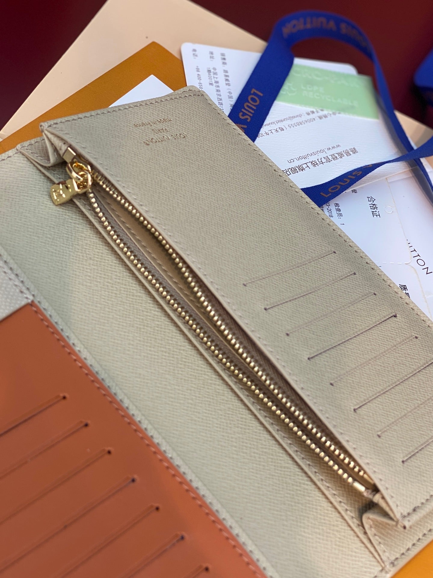 Louis Vuitton monogram zip wallet in cream with gold-tone zipper and card slots