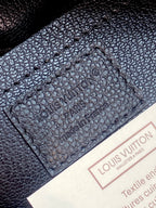 Louis Vuitton bag, dark textured leather interior panel with embossed brand markings