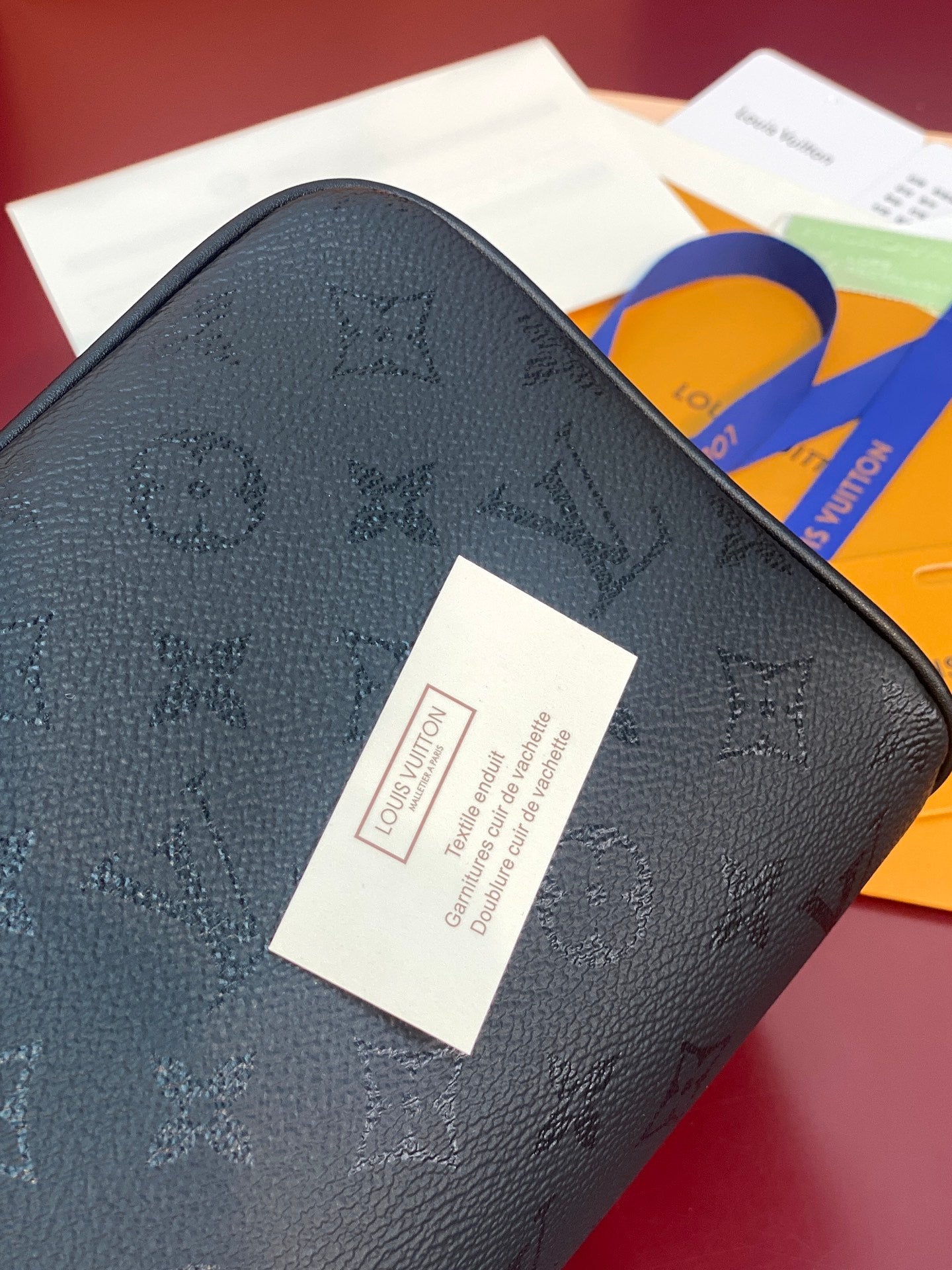Louis Vuitton bag exterior with embossed monogram texture and white label