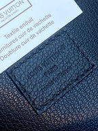 Close-up of Louis Vuitton dark blue textured leather with embossed monogram pattern