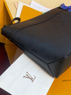 Louis Vuitton leather clutch bag, dark brown/black tone with zip top and wrist strap.