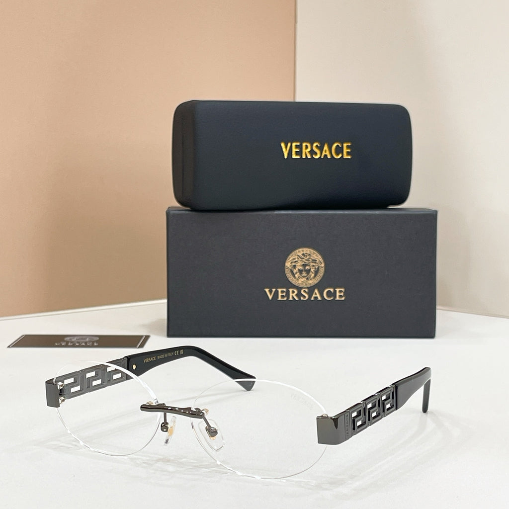 Designer eyeglasses with black temples, gold logo detail, and clear lenses