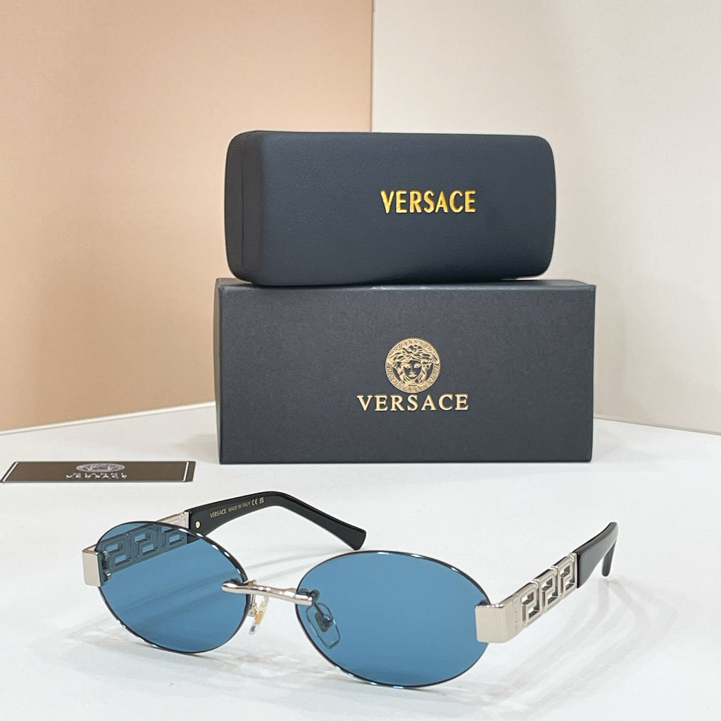 Designer sunglasses with blue mirrored lenses, black frame, and gold geometric temples