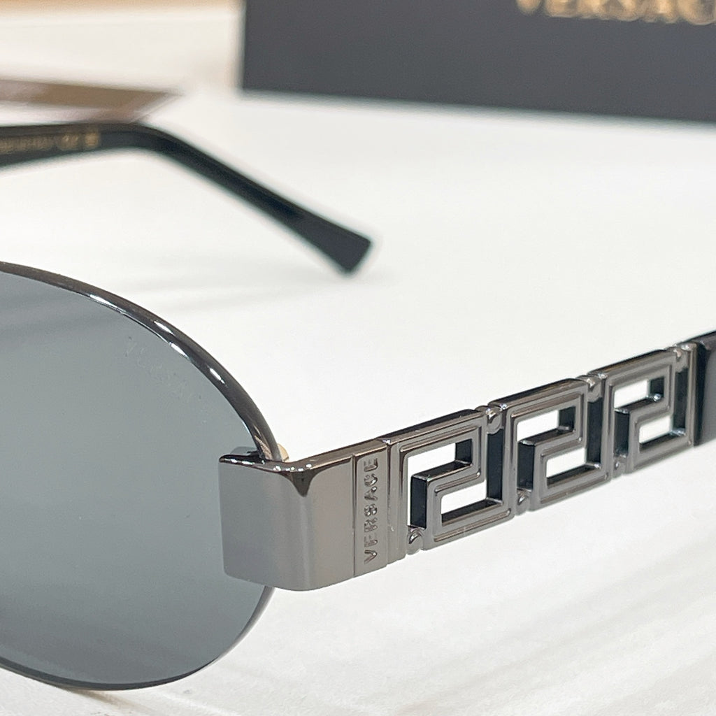Versace sunglasses temple close-up with Greek key pattern and metal logo detail