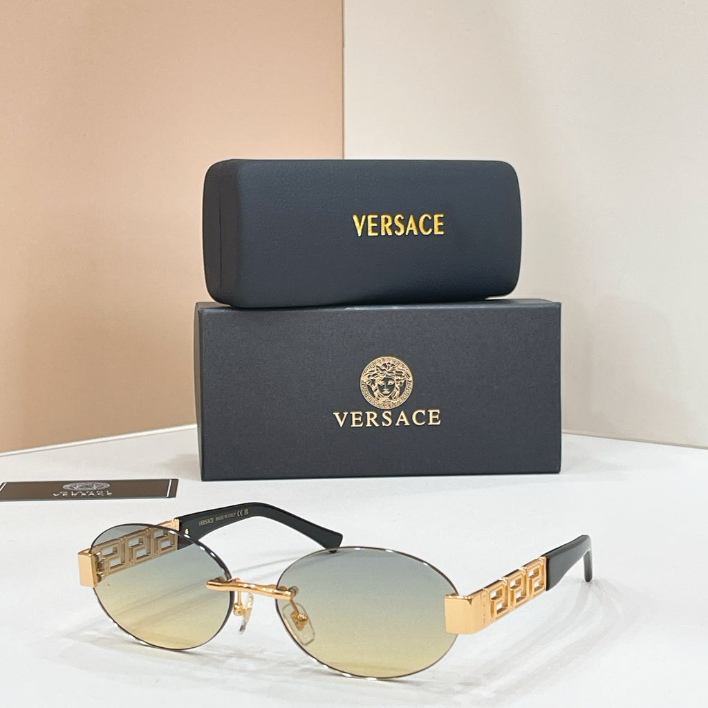 Versace round sunglasses with gold-tinted lenses, black frame, and gold patterned temples