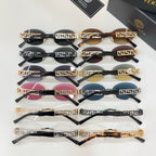 Versace sunglasses assortment with black frames, Greek key detailing, and colored lenses