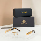 Sunglasses with clear lenses, gold-tone metal frame, tortoise-style temple pieces