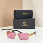 Sunglasses with pink tinted lenses, gold-tone metal frame, pink temple accents