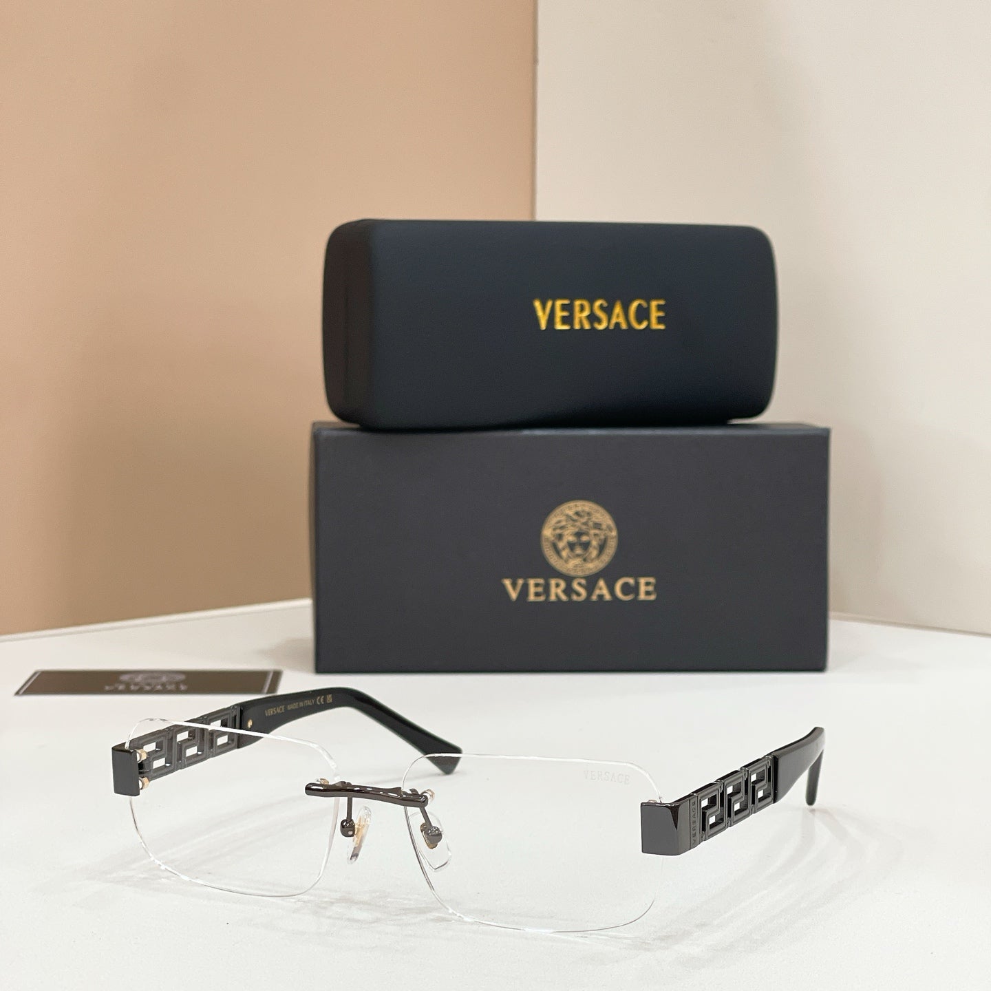 Sunglasses with clear lenses, gold-tone metal frame, dark temple accents