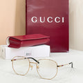 Gold-tone and black full-rim eyeglasses with clear lenses and red-green detail