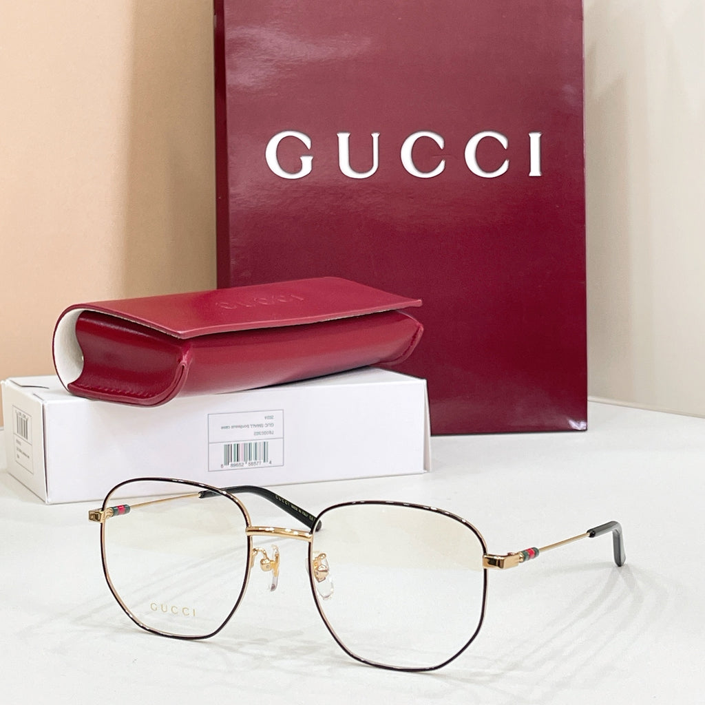 Gold-tone and black full-rim eyeglasses with clear lenses and slim black temple arms