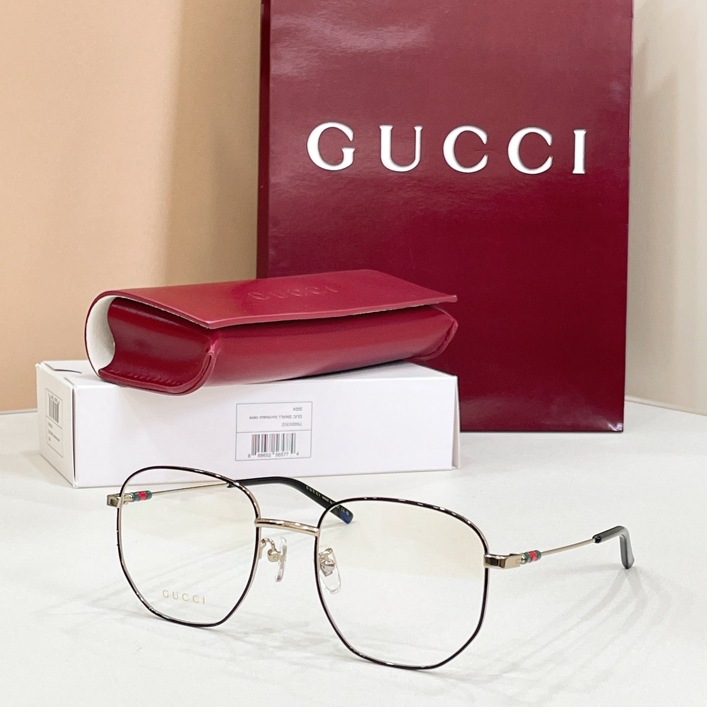 Gold-tone and black full-rim eyeglasses with clear lenses and multicolor temple accents