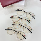Set of clear-lens eyeglasses with gold-tone frames, black temples, colorful accent pins