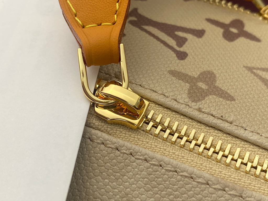 Louis Vuitton bag zipper with gold hardware and beige leather trim