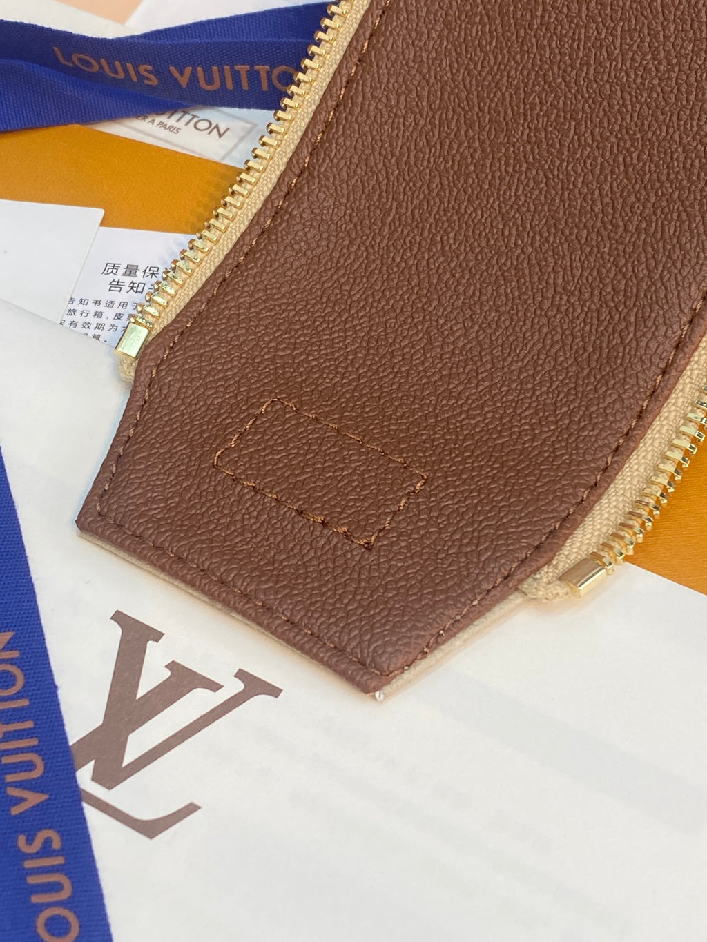 Louis Vuitton monogram bag back panel, brown leather patch with stitched logo