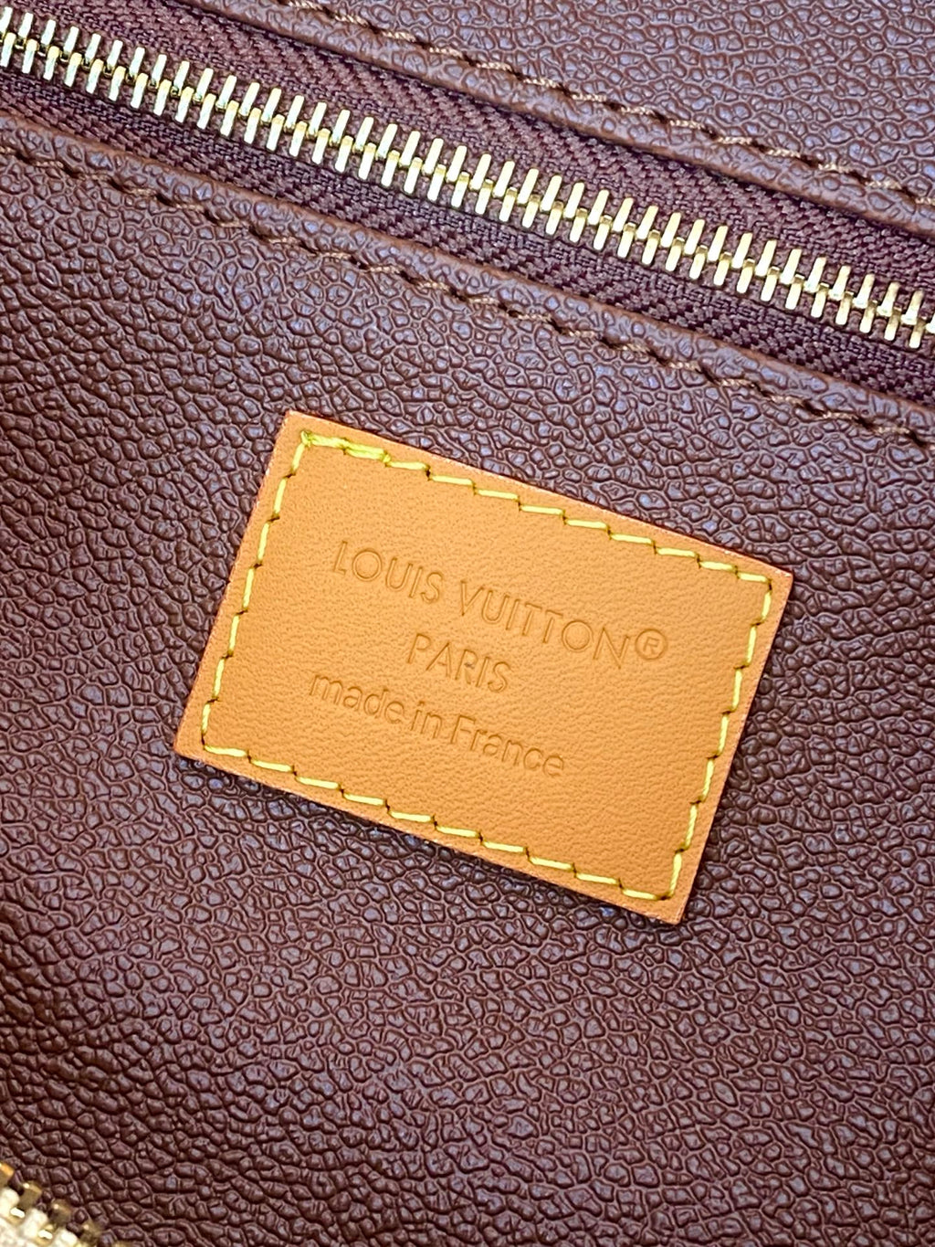 Louis Vuitton monogram bag leather tag, stitched rectangular label with Paris text