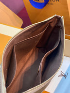 Small monogram pouch bag interior view, dark lining with gold zipper edge