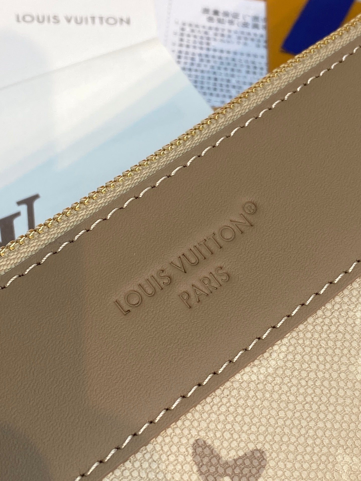 Small pouch bag corner detail with Louis Vuitton stamp and stitched leather trim