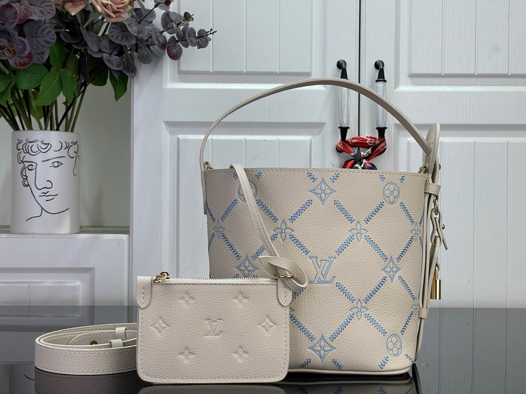Louis Vuitton hobo bag with blue monogram pattern and tan top handle, plus crossbody pouch