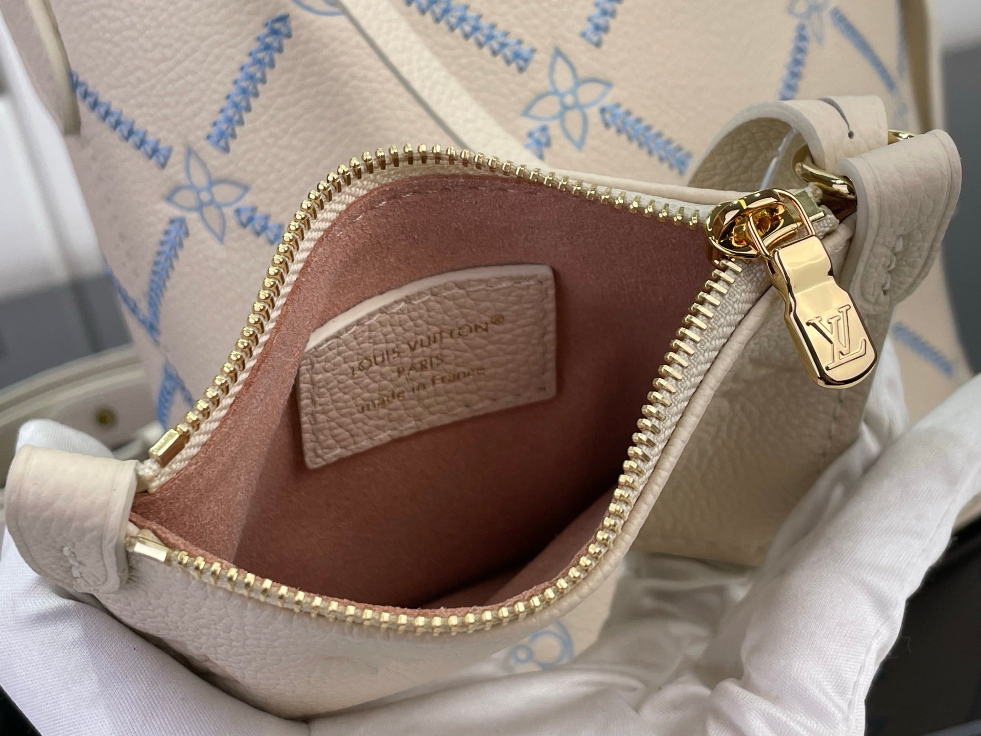 Louis Vuitton patterned bag with zipper and interior pocket, shown open