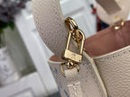 Louis Vuitton bag clasp and gold lock detail with side tab on light beige leather