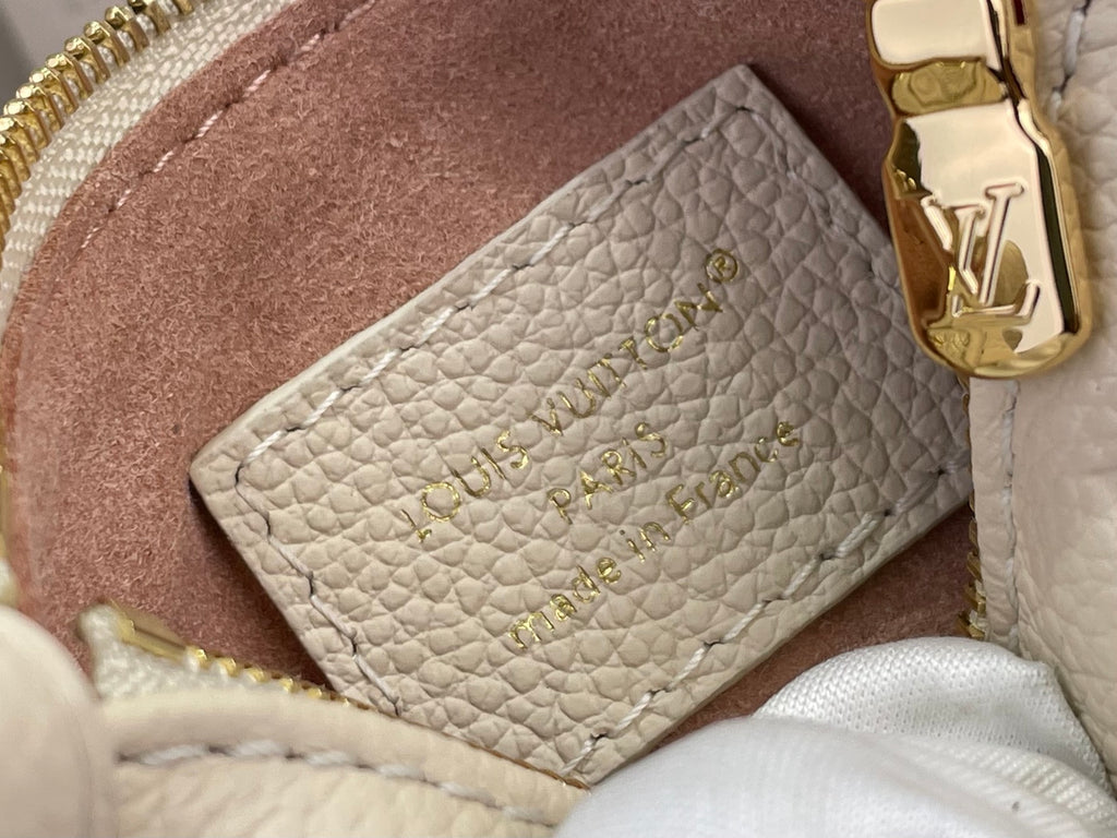 Louis Vuitton interior card holder pocket in light beige pebbled leather, close-up