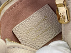 Louis Vuitton interior card holder pocket in light beige pebbled leather, close-up