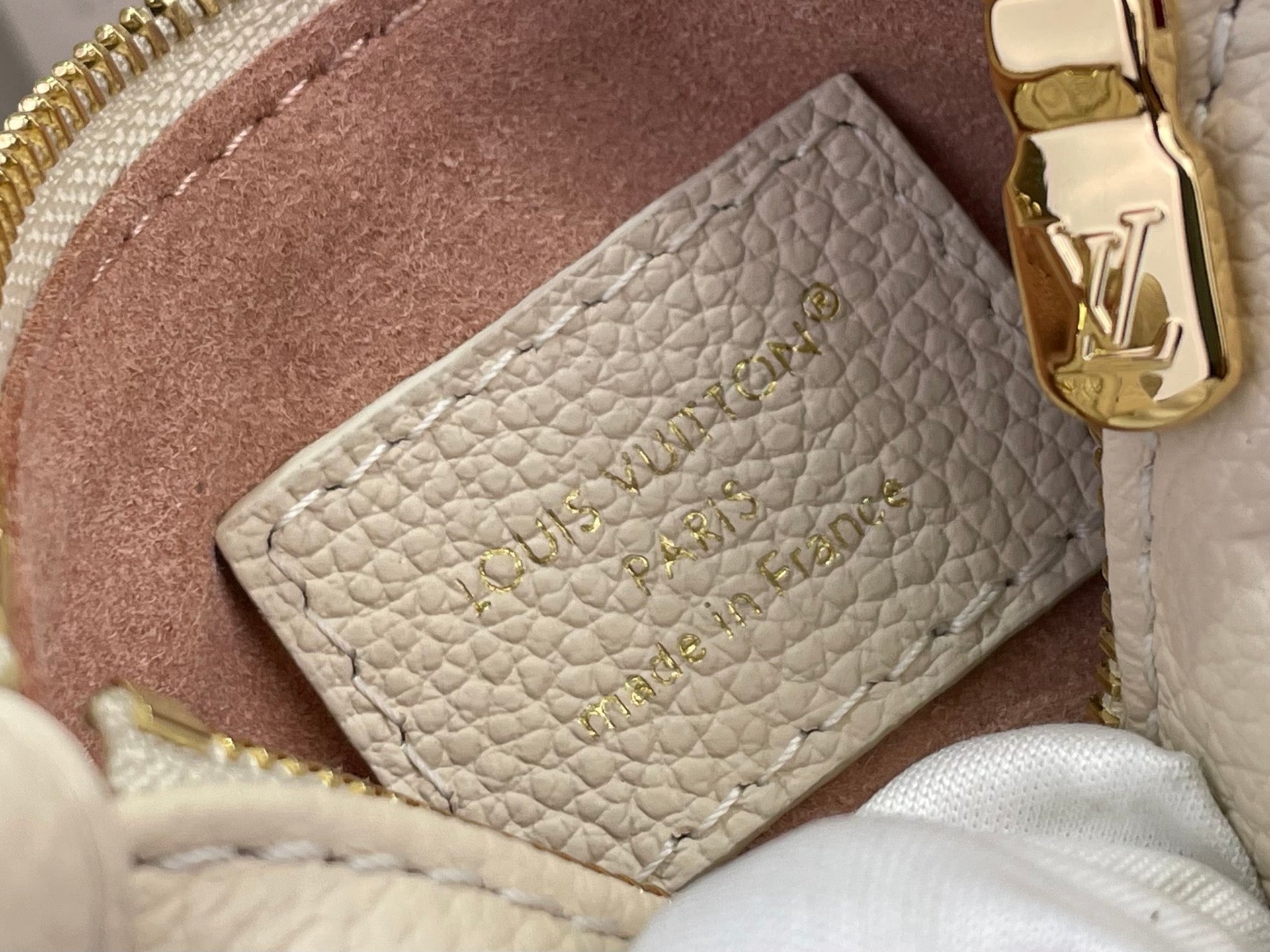Louis Vuitton interior card holder pocket in light beige pebbled leather, close-up