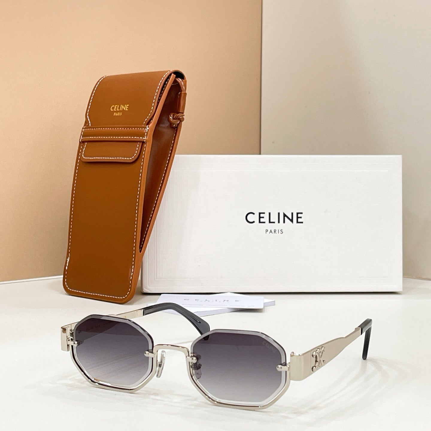 Celine sunglasses with dark purple lenses and silver-tone frame, shown with brown case
