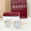 Gucci round sunglasses, gold-tone frame with light gray lenses