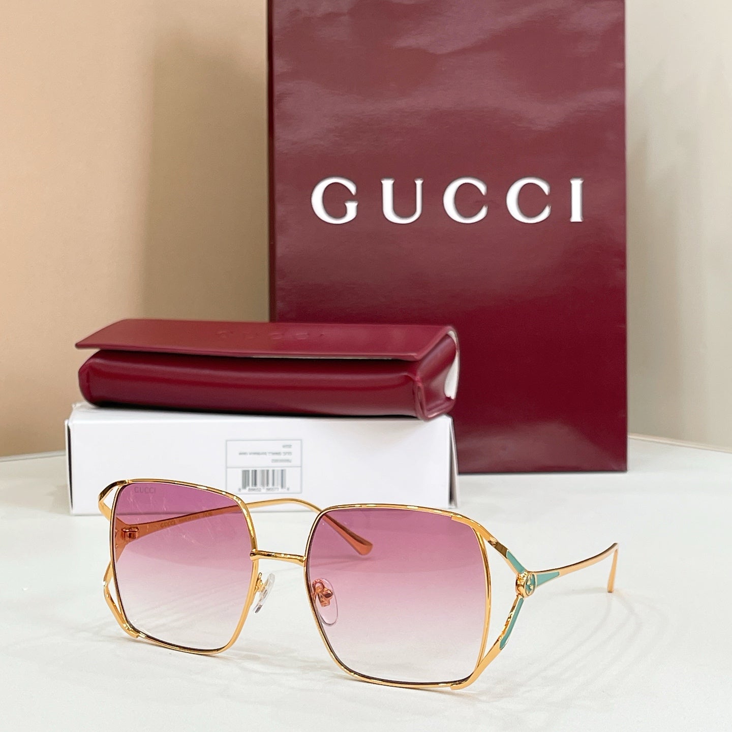 Gucci oversized square sunglasses with gold frame and gradient rose lenses