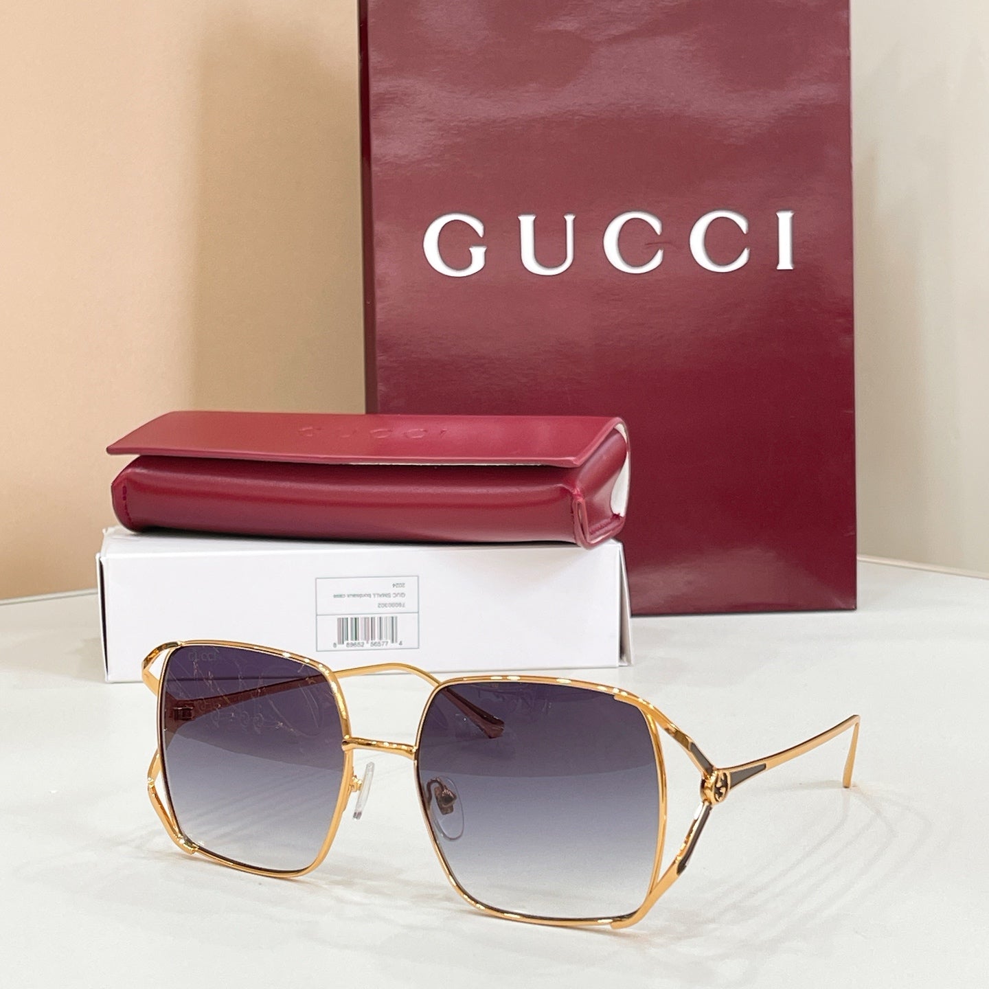 Gucci oversized square sunglasses with gold frame and dark gradient lenses