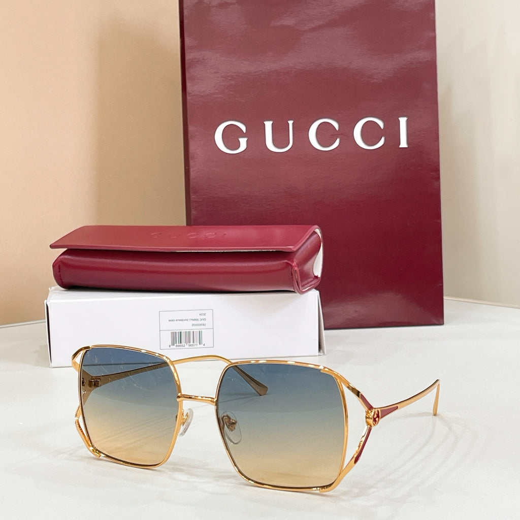 Gucci oversized square sunglasses with gold frame and cool-toned gradient lenses