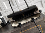 Chanel handbag with black leather flap and houndstooth side panels, gold-tone feet.