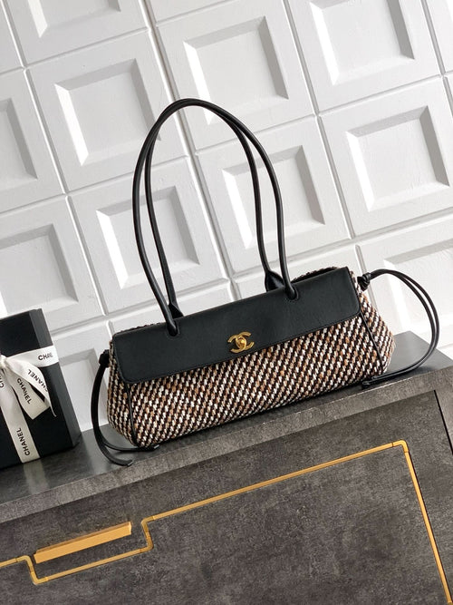 Chanel handbag with black leather top handles and woven houndstooth body, gold logo.