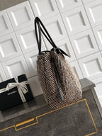 Black and multicolor tweed handbag on side view with long black handles